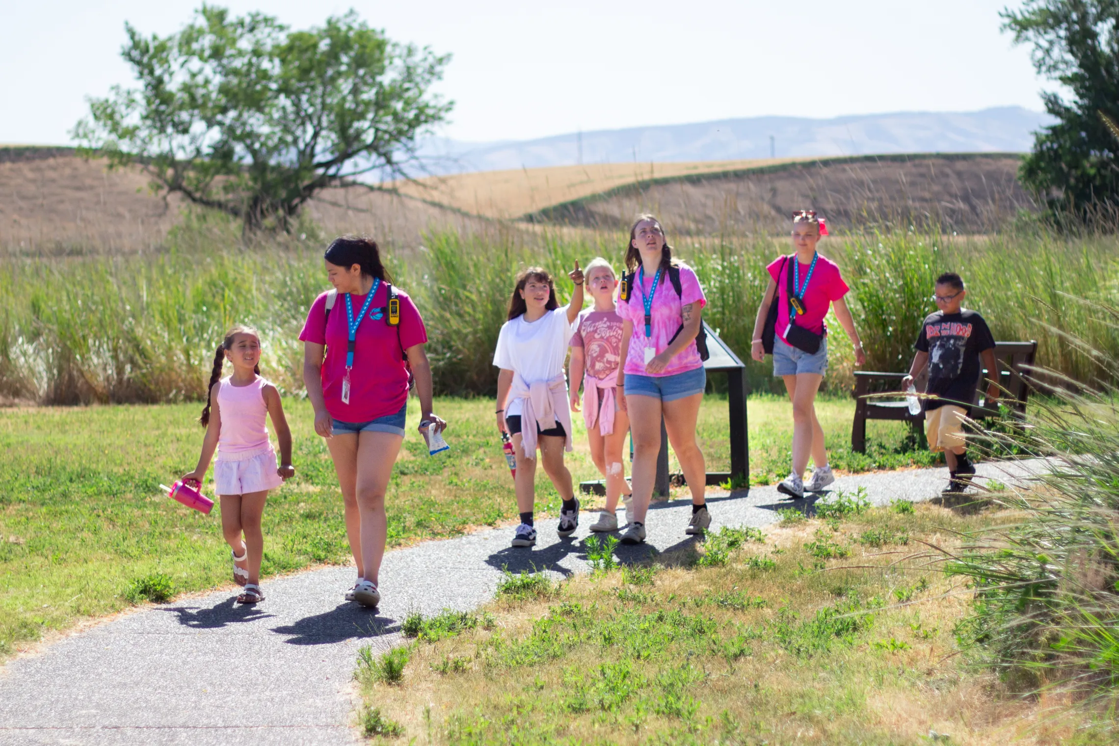 Camp counselors walk with camper kids