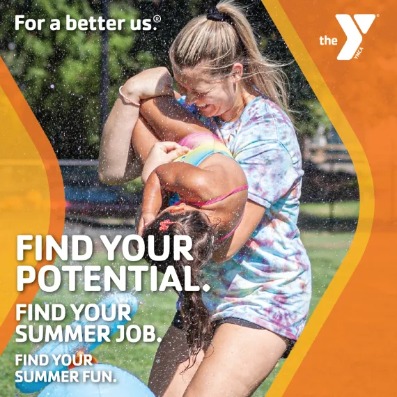 Find your potential. Find your summer job. Find your summer fun. For a better us. Image of female counselor holding child camper, laughing while running through spraying water.