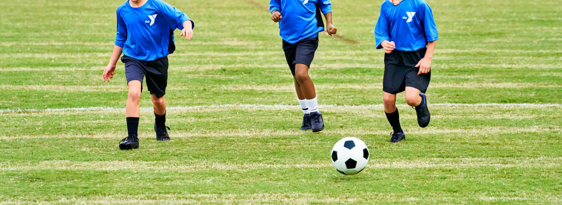 Three girls playing soccer.