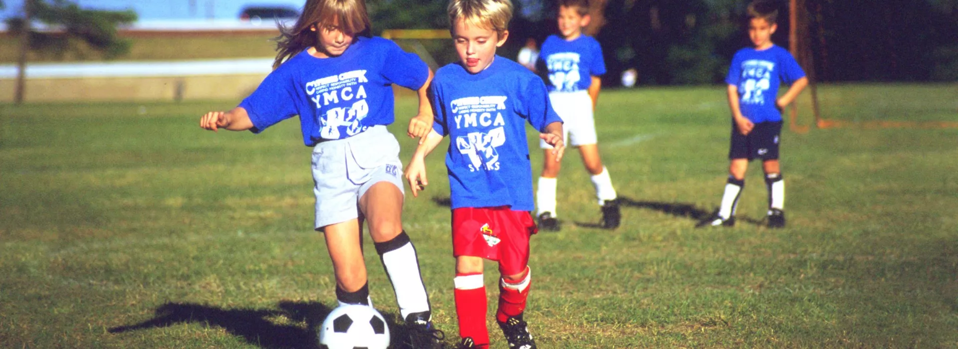 Mixed socccer team playing outside.